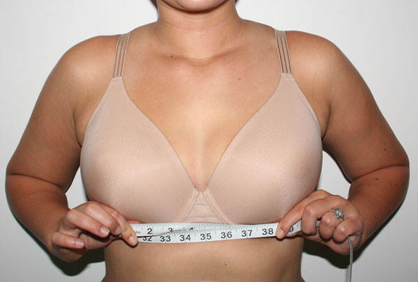 Image of a person measuring their ribcage for a bra fitting.