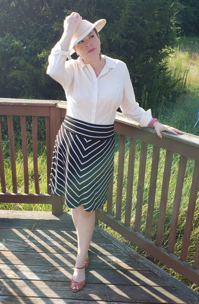 Image of button front tucked into a striped skirt