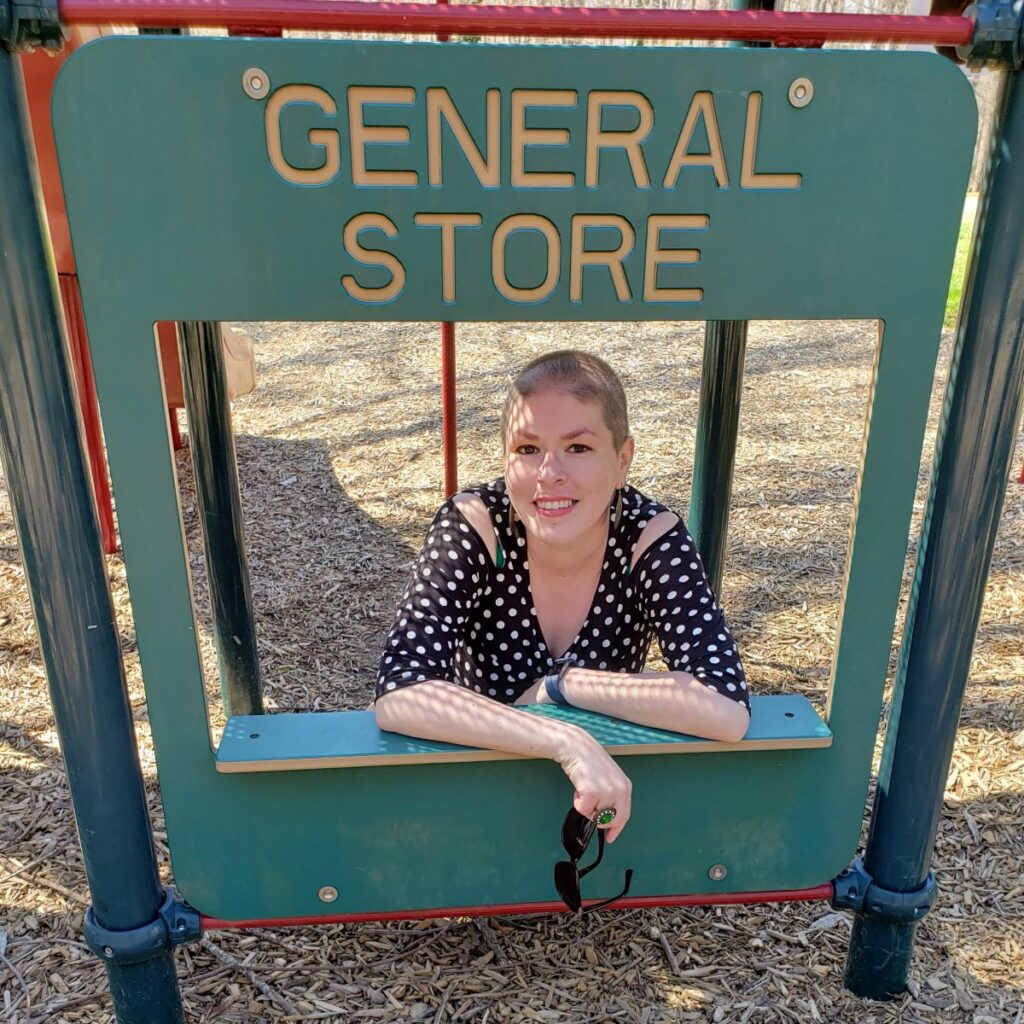 Image of the Twisted Top on the body, front facing behind a general store playground toy