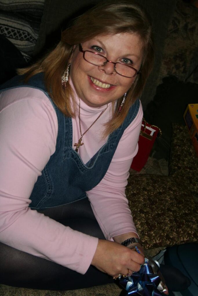 Image of my mom opening up Christmas gifts