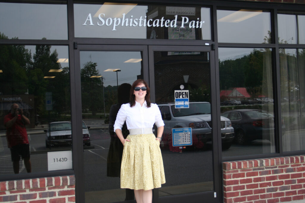 An image of me on opening day in front of the store