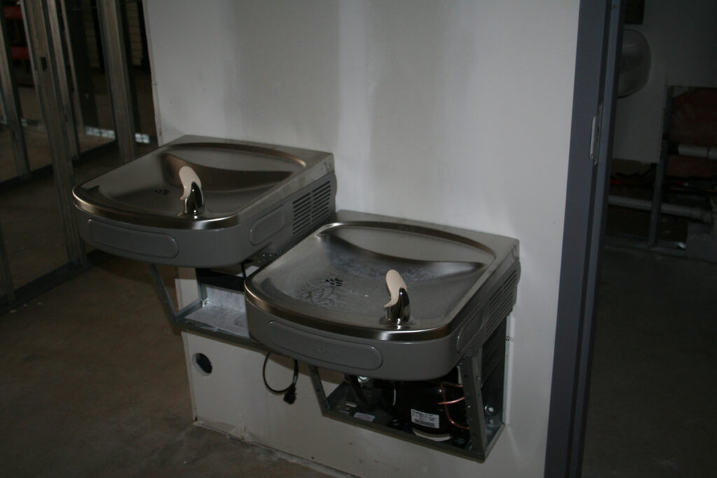 Image of water fountains on unfinished wall